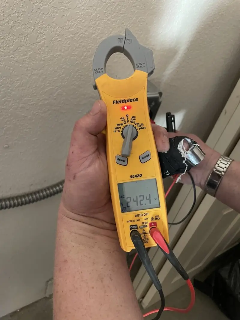 Voltage testing with clamp meter during Recessed Lighting Installation in Cherry Creek